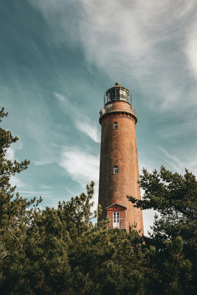 pexels photo 34063930 34063930 Stunning view of the Darßer Ort lighthouse in Born a. Darß, Germany with lush greenery.